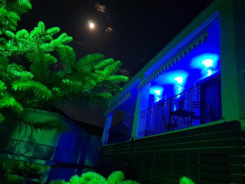 a building with blue lights on it at night at Mondeus Inn Luxury in Deskáti