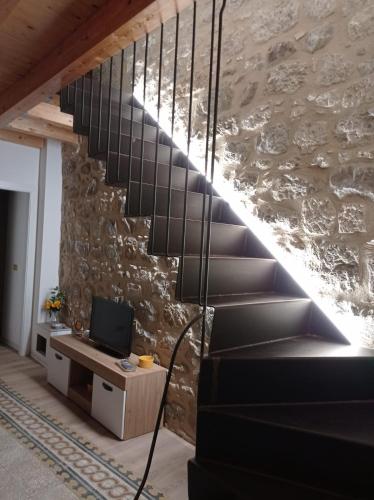 a staircase in a house with a stone wall at Casa Vacanze Borgo Gulini da Anna in Petralia Soprana