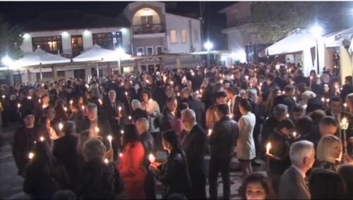 a large group of people standing in a crowd holding candles at Mondeus Inn Luxury 