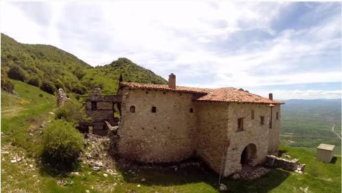 an old building on top of a hill at Mondeus Inn Luxury in Deskáti