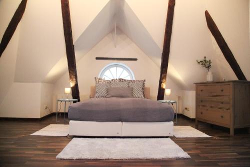 a bedroom with a bed in the attic at Wunderschöne Dachgeschoss - Maisonette (108qm - 3.OG) in Rostock