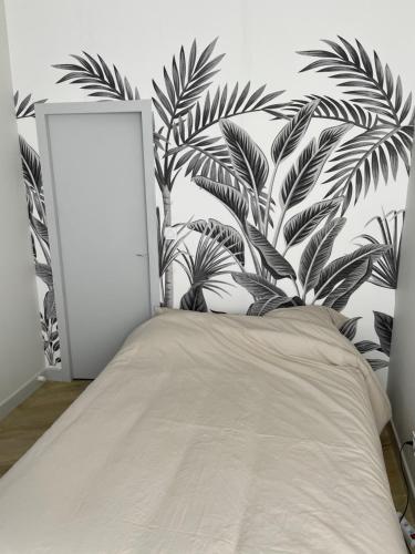 a bedroom with a bed with a plant wall at Le Cœur d’Agen in Agen