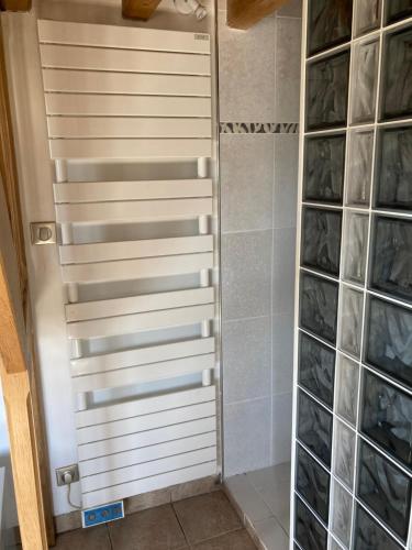 a shower door in a bathroom with a glass wall at Charmante maisonnette indépendante in Broye