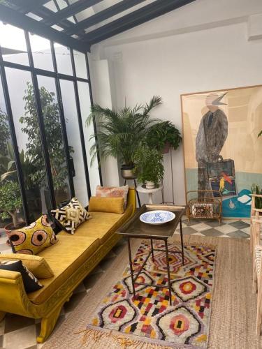 a living room with a couch and a table at Hospederia Santa Clara in Utrera