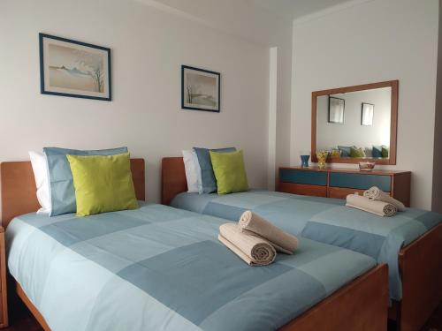 A bed or beds in a room at Blue Boat House - The Atlantic Breeze