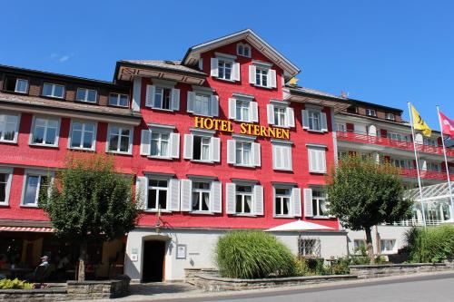 a red hotel with a sign on the front of it at Hotel Sternen Unterwasser in Unterwasser