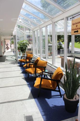 a row of chairs in a building with windows at Hotel Sternen Unterwasser in Unterwasser