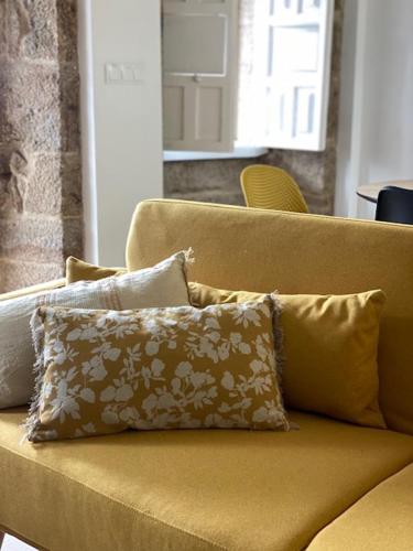 a brown couch with a pillow on it at Celanova House in Celanova
