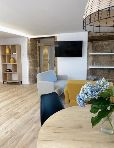 a living room with a table and a couch at Celanova House in Celanova