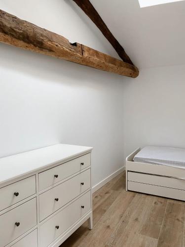 a bedroom with a bed and a white dresser at Celanova House in Celanova
