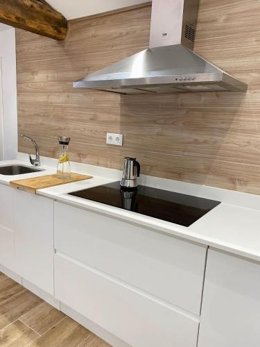 a kitchen with a sink and a stove top oven at Celanova House in Celanova