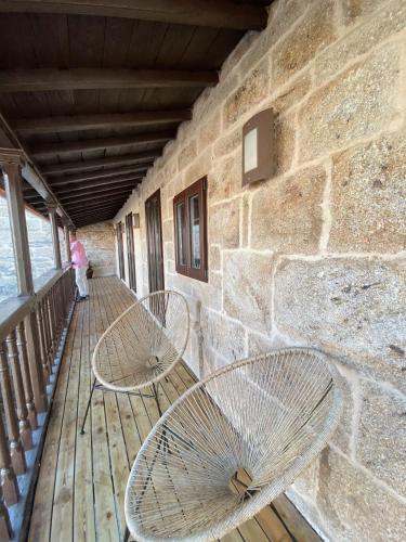 two metal chairs sitting on a wooden deck at Celanova House in Celanova