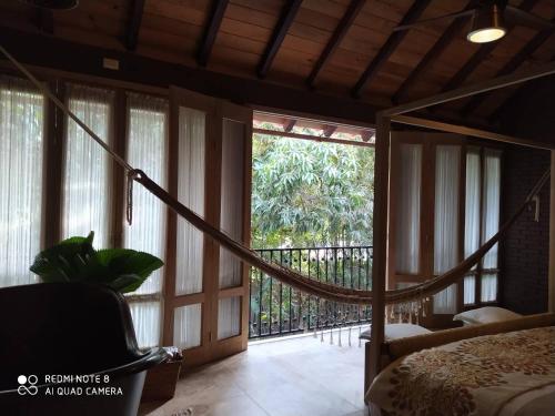 a bedroom with a hammock in a room with a balcony at Hotel Bendita Luna in Mazunte