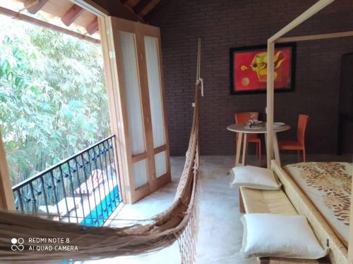 a hammock in a room with a balcony at Hotel Bendita Luna in Mazunte