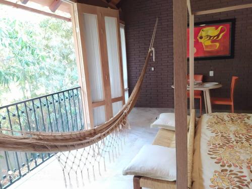 a hammock in a room with a balcony at Hotel Bendita Luna in Mazunte