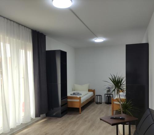 a living room with a bed and a large window at 2 Zimmerwohnung in Bietingen in Gottmadingen