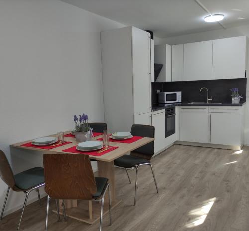 a kitchen with a table and chairs in a room at 2 Zimmerwohnung in Bietingen in Gottmadingen