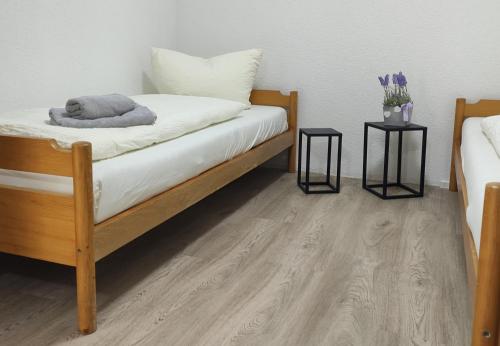 a room with a bed and two end tables at 2 Zimmerwohnung in Bietingen in Gottmadingen
