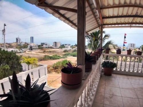 a balcony with lots of potted plants on it at Casa de la colina in Santa Elena