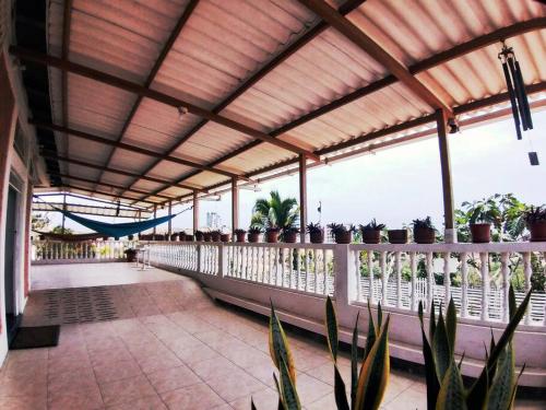 a porch with potted plants on a balcony at Casa de la colina in Santa Elena