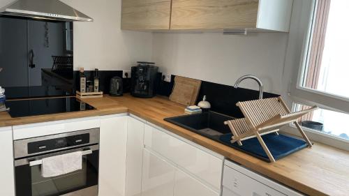 a kitchen with a chair sitting on a counter at Large apartment near the beaches of Mourillon in Toulon