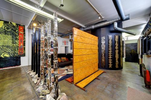 a room with a large wooden door in the middle at SPACE CASTLE: a 1950s Gas Station transformed into an Art Themed Wonderland in Truth or Consequences