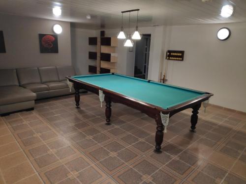 a pool table in a room with a couch at Mini Chisinau Hotel in Chişinău