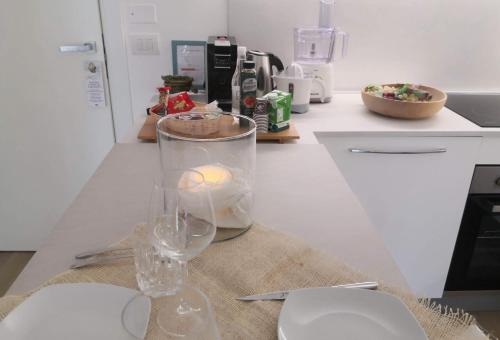 a candle in a vase on a counter in a kitchen at Dimore Capirro Charming Family House in Trani