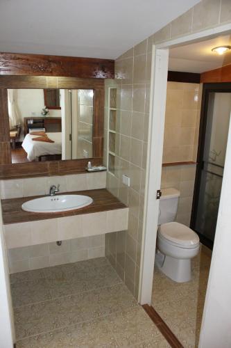 a bathroom with a toilet and a sink and a mirror at Sea Scene Resort in Wok Tum