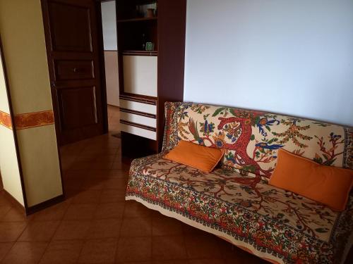 a couch with two pillows on it in a room at Gioiamare in Martinsicuro
