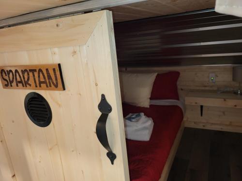 a small room with a small bed in a cabin at THE ORCHARD (HOSTEL WITH PRIVATE BUNKS) in Radium Hot Springs