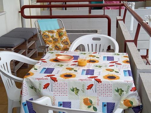a table with a table cloth with oranges on it at Gioiamare in Martinsicuro