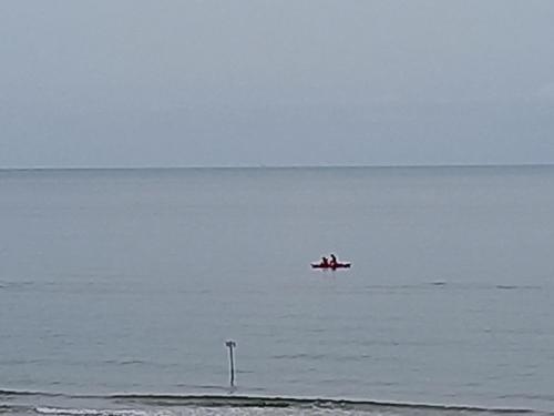 a plane is flying over the water in the ocean at Gioiamare in Martinsicuro