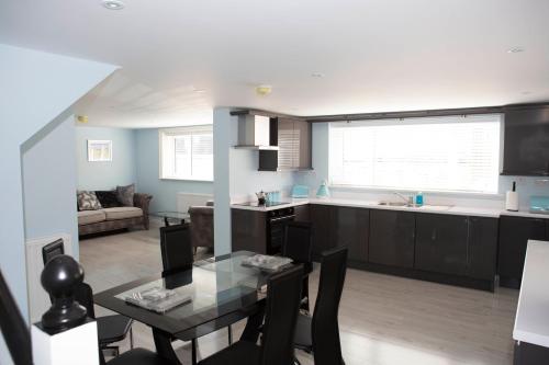a kitchen and dining room with a table and a kitchen and a living room at 2 Slieve Gullion View Newry in Newry