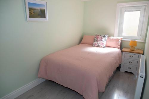 a small bedroom with a bed and a window at 2 Slieve Gullion View Newry in Newry