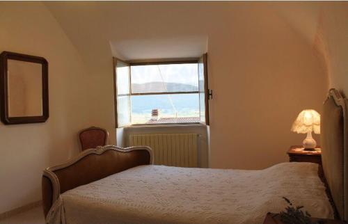 a bedroom with a bed and a window at Casetta Mimì in San Pio delle Camere