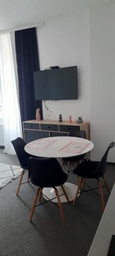 a table and chairs in a living room with a television at Apartments DOLAC Zagreb in Zagreb