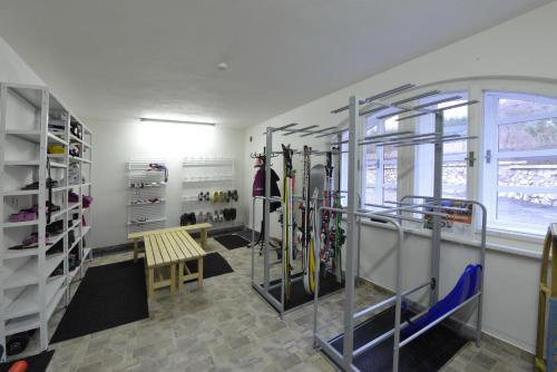a room with a bunch of skis in it at Wellness Pension Fulda Černý Důl in Cerny Dul