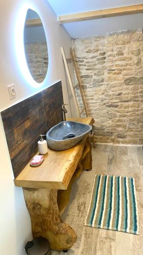 a bathroom with a sink on a wooden table with a window at Le Grenier - Gîte de Charme La Rochelle in Saint-Médard-dʼAunis