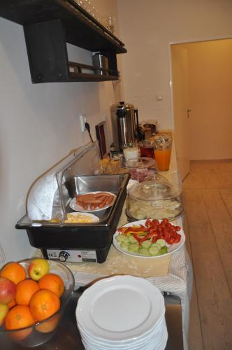 a kitchen counter with many plates of food on it at Wellness Pension Fulda Černý Důl in Cerny Dul