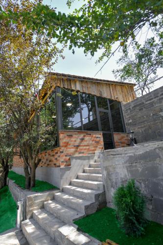 a brick house with stairs leading up to it at Madin Eco Hotel in Debed