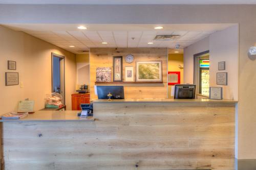 a lobby with a wooden counter with a counter top at Country Inn & Suites by Radisson, Crystal Lake, IL in Crystal Lake