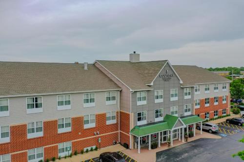 an aerial view of a hotel with a parking lot at Country Inn & Suites by Radisson, Crystal Lake, IL in Crystal Lake