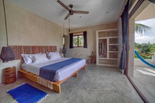 a bedroom with a bed and a hammock in it at Hotel Boutique Can Cocal El Cuyo in El Cuyo