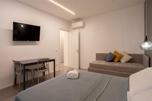 a bedroom with two beds and a desk and a television at Car.Ma - comfy rooms in Porto SantʼElpidio