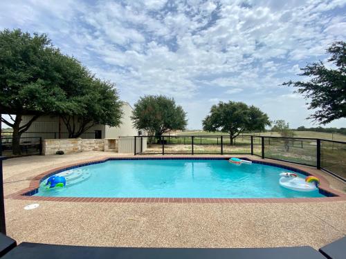 a small swimming pool with a fence around it at Blue Hills Ranch in McGregor