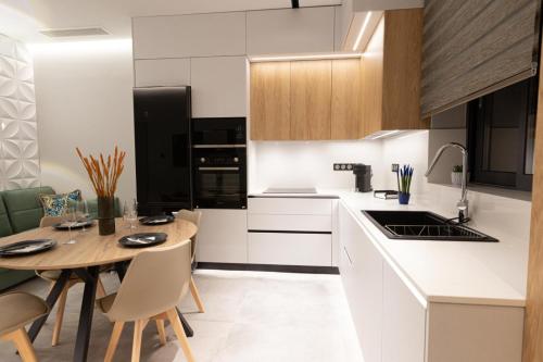 a kitchen with a table and a dining room at BillMar Luxury Apartment in the center of Gythio in Gythio
