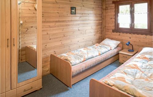 ムシチツェにあるNice Home In Mscice With Kitchenの木造キャビン内のベッド2台が備わる部屋