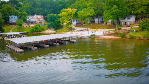 a dock in the middle of a body of water at Lakeshore Fishing Cabin #2 in Lake Ozark