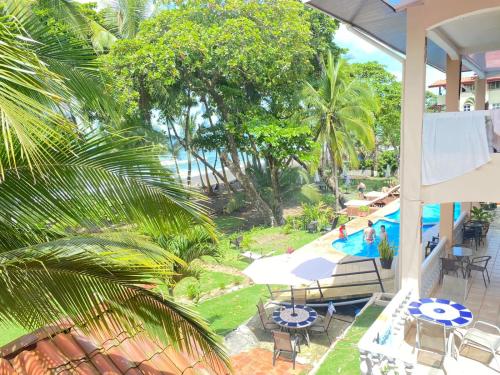 a view of a pool from the balcony of a resort at Hotel Beachfront Vista Hermosa in Jacó